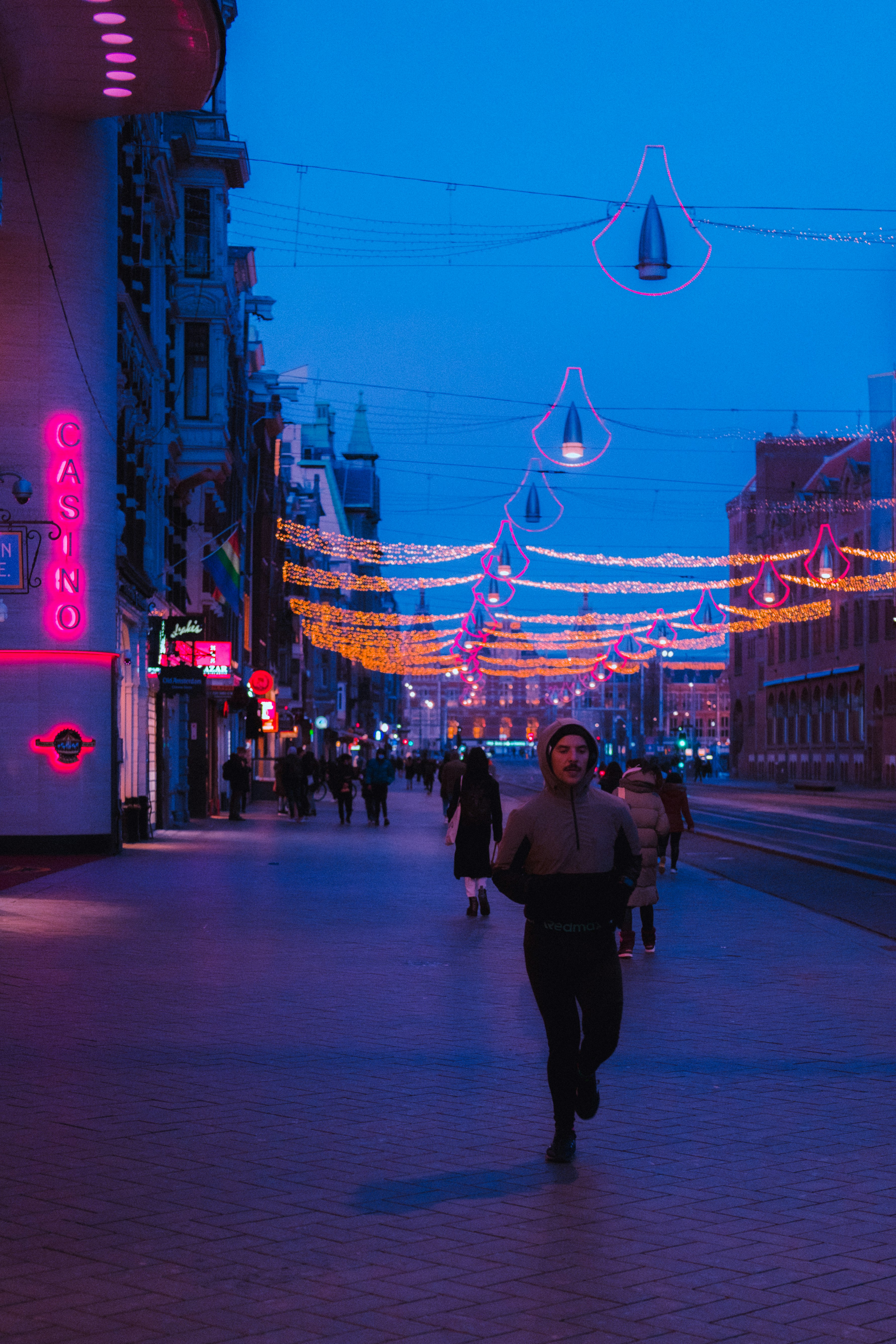 woman in black jacket walking on street during night time
